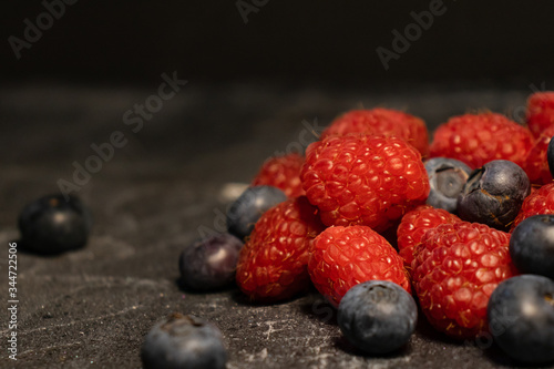 Close-up of berries (blueberries, raspberries) on a dark background.