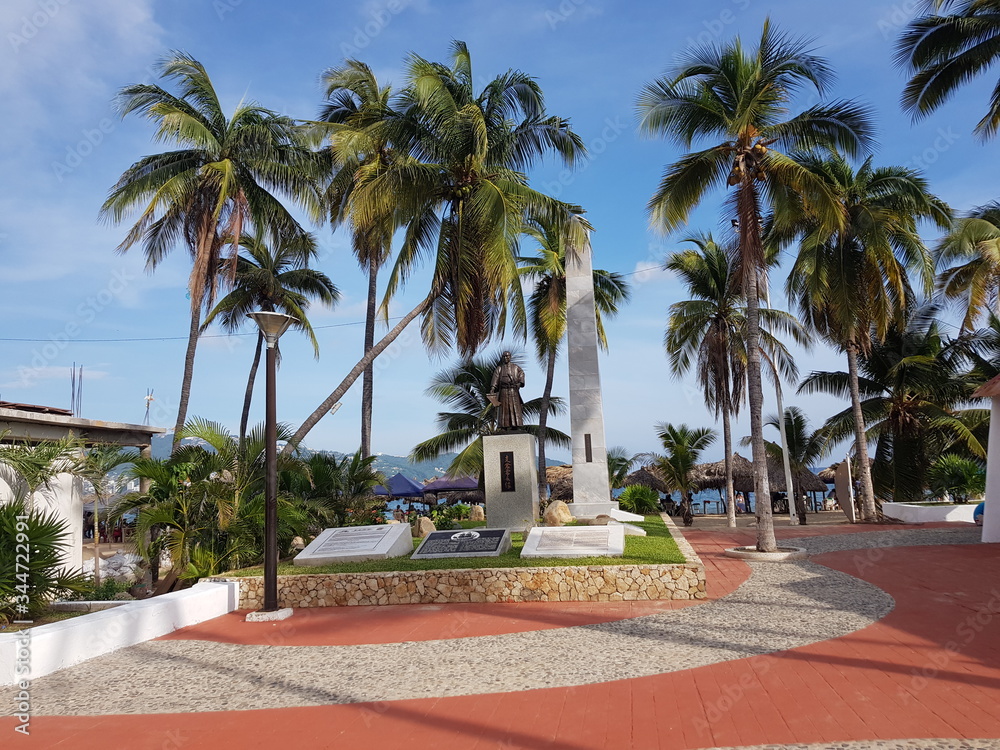 Plaza Japon, on Costera Miguel Aleman street in Acapulco, with a statue and palm trees