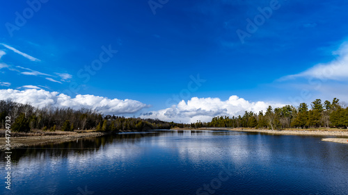 Fototapeta Naklejka Na Ścianę i Meble -  Waterfront Blue Sky White Clouds