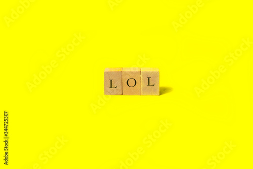 wooden cube with letters on yellow background