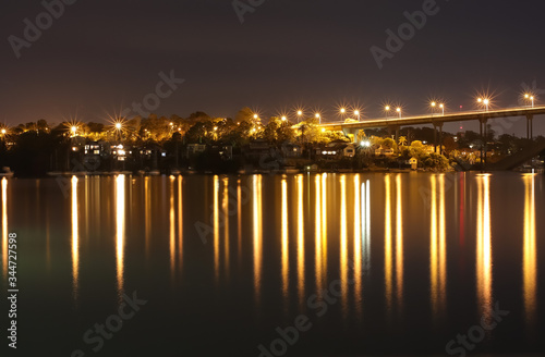 Night Long exposure of Gladesville Bridge in Sydney Australia illuminated by the bright lights and smooth harbour waters light up  © Elias Bitar