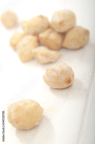 Candlenut on a wooden background (Aleurites moluccanus)