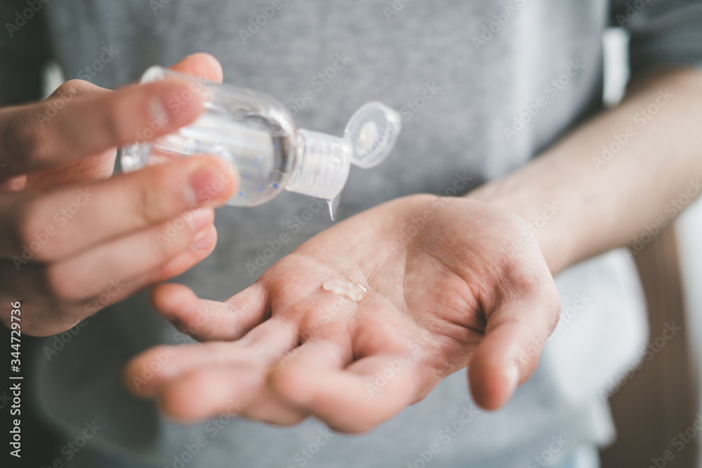  men using a small hand-held antibacterial hand sanitizer, coronavirus protection