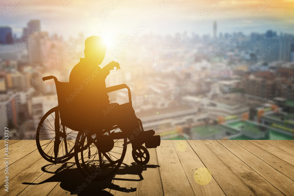 Silhouette of disabled person on wheelchair sunset background. International Disability Day or Handicapped sport. Life in the education age of special syndrome children, Autistic Awareness Day concept - obrazy, fototapety, plakaty 