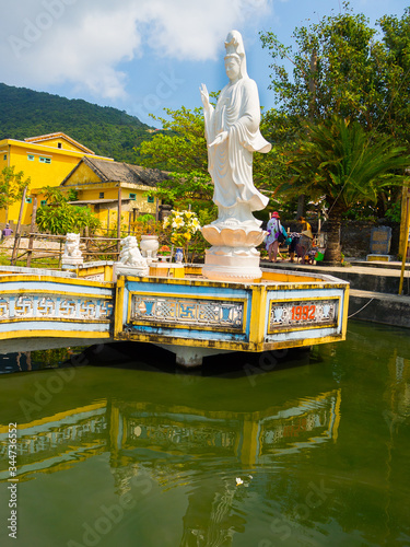 Beautiful view of a white stoned statue in the border of the pier, bin Hoian in Vietnam. Hoian is recognized as a World Heritage Site by UNESCO photo