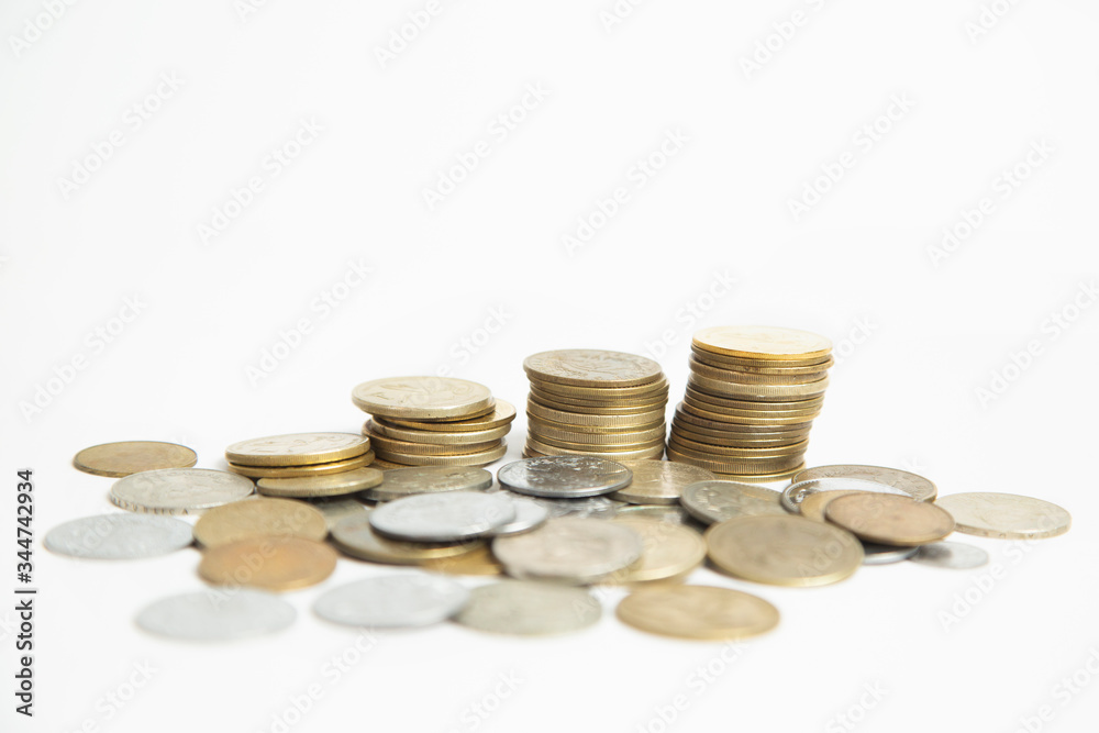 Coins stacked in small towers - Coins isolated from white background - Pile of queztales currency of Guatemala Coins stacked in small towers - Coins isolated from white background - Pile of queztales currency of Guatemala