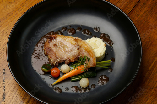 Pork chop with vegetables. Exquisite dish, creative restaurant meal concept, haute couture food.