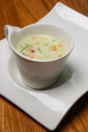 Creamy vegetable soup served in a bowl on the restaurant table