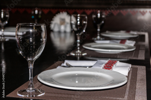restaurant table setting, wine glasses and plates