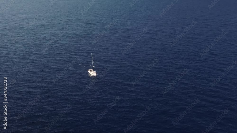 Aerial view on white sailing yacht floating across Mediterranean sea. Lipari Islands. Sicily, Italy