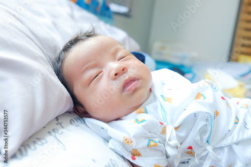 Infant baby boy sleep on blangket photo