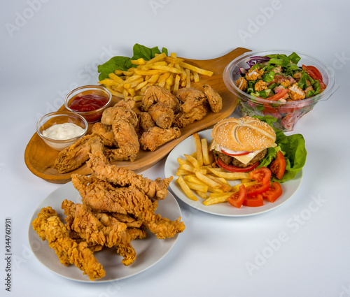 plate with french fries, crispy, fried meat, vegetables, juices and bread