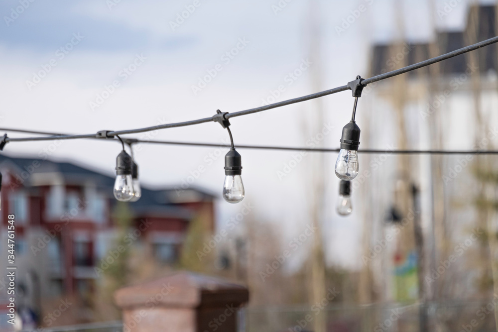 Lights strung out on wire in outside space Lights strung out on wire in outside space