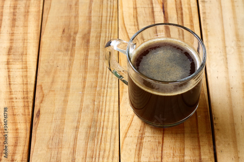 Sugar-free black coffee for health lovers. Black coffee in the morning for freshness. Black coffee on a wooden table.