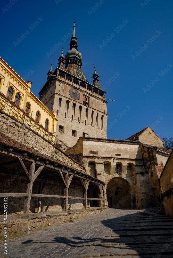 the clock tower in Sighisoara and the cobbled alley