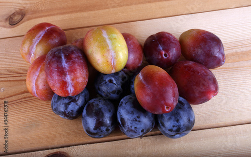 Different color plums on table