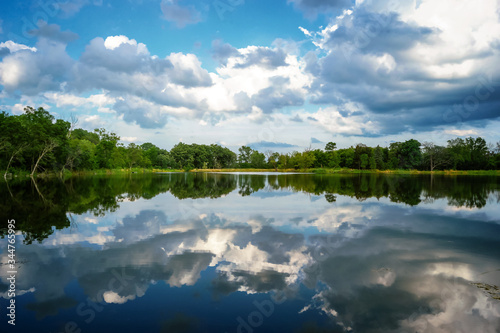 A lake view with the sky reflecting off the still surface at Independence Grove Forest Preserve in Libertyville, Illinois USA.