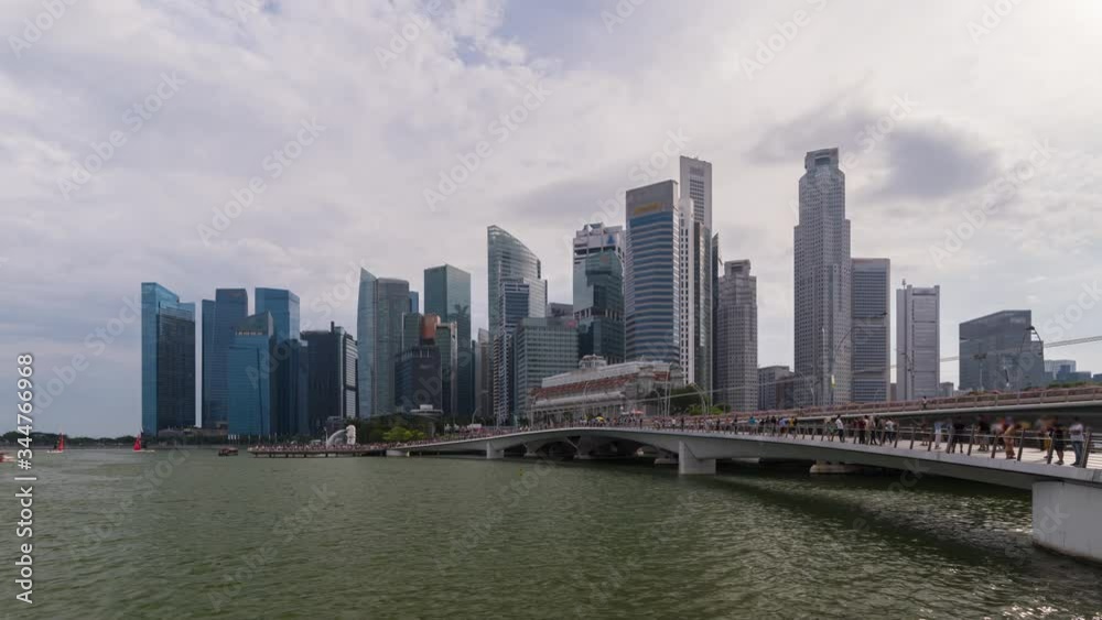 Daytime time lapse of Singapore city downtown area from the bridge crowded with tourists