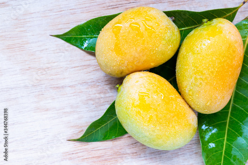 Wild mango on wooden background photo