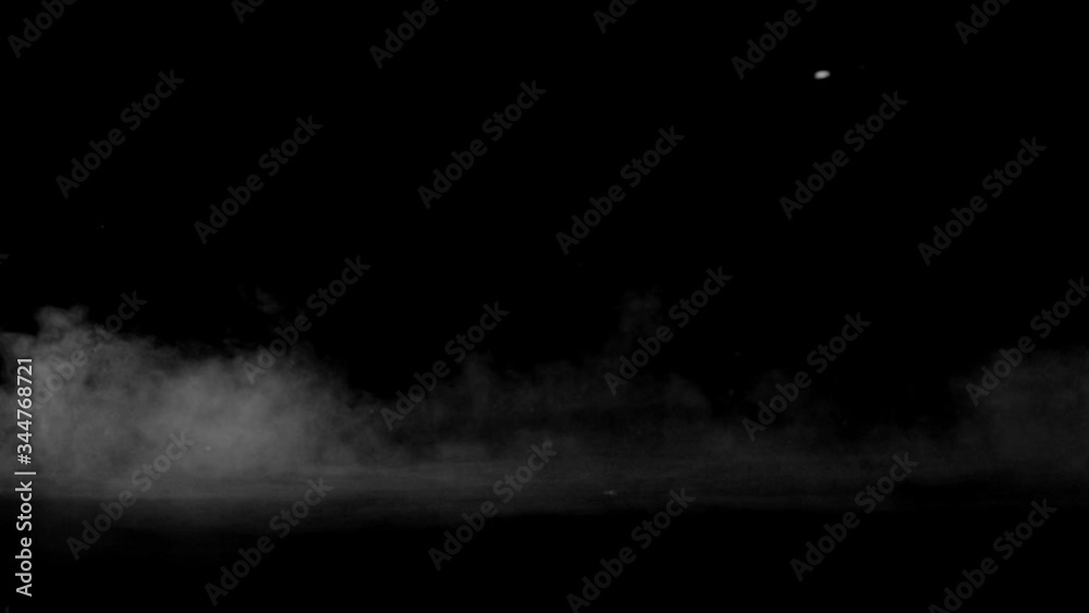 Smoke. Cloud of cold fog in blue light spot on black background. Abstract white smoke in slow motion. Light, white, fog, cloud, abstract, smoke, black, background, 4k, ice smoke cloud. Floating fog.
