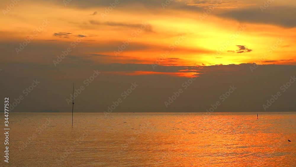sunset orange sky and dark yellow cloud moving over sea sunset orange sky and dark yellow cloud moving over sea