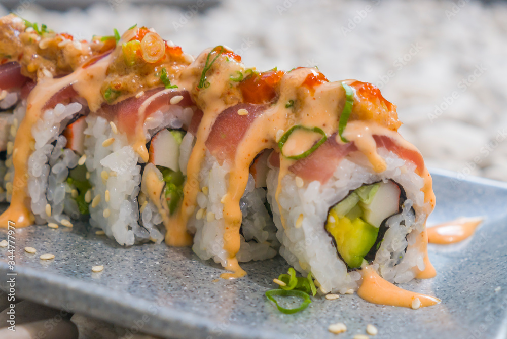 Japan gourmet cuisine - closeup detail on delicious and delicate dish of Japanese sushi rolls in slate on stone bg in traditional healthy Asian food and creative oriental dining Japan gourmet cuisine - closeup detail on delicious and delicate dish of Japanese sushi rolls in slate on stone bg in traditional healthy Asian food and creative oriental dining