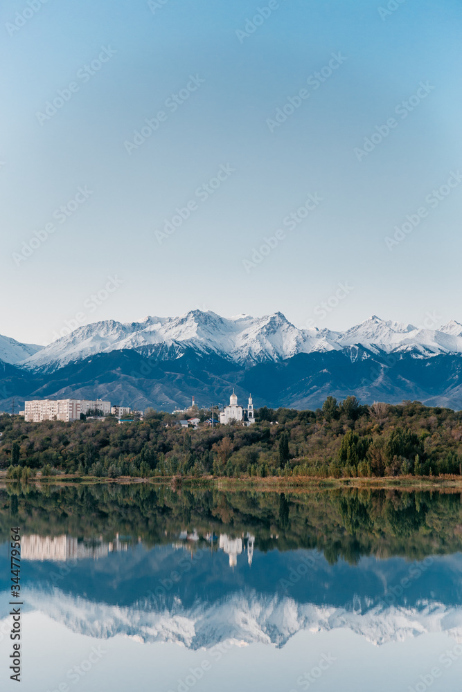 blue lake against the backdrop of mountains and clear sky nature at dawn