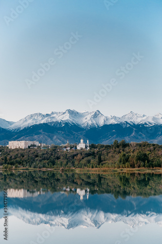 blue lake against the backdrop of mountains and clear sky nature at dawn