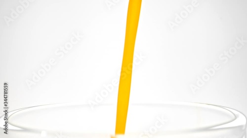 orange juice drop in glass slow motion