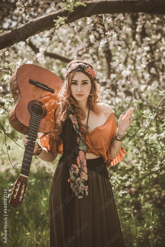 Gypsy woman with guitar at field, lifestyle, ideas for costume on Halloween