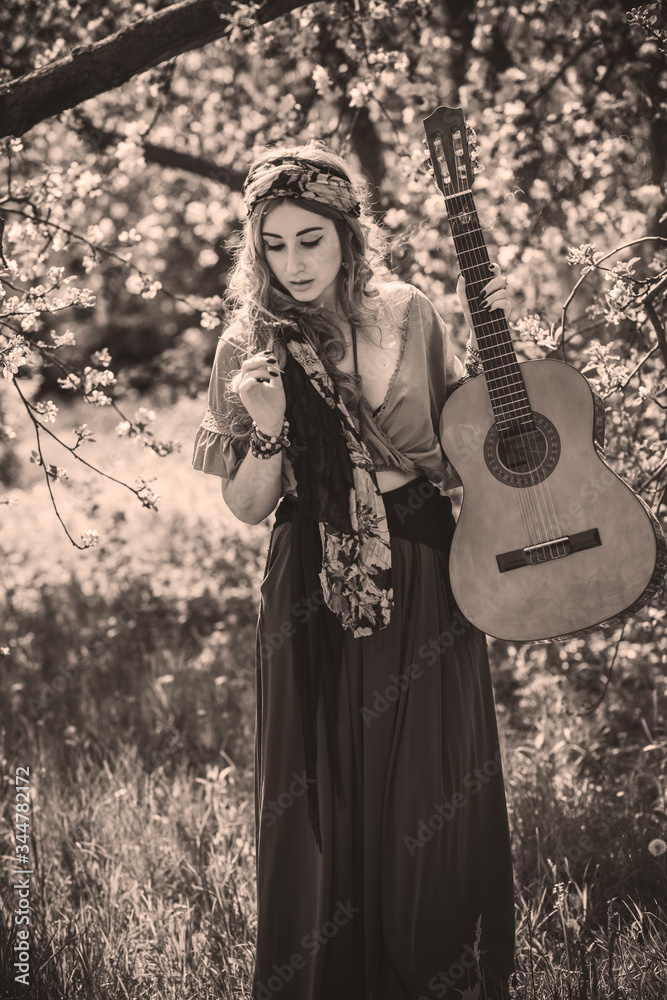 Gypsy woman with guitar at field, lifestyle, ideas for costume on Halloween