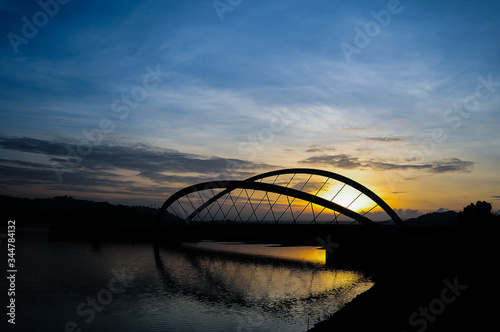Beautiful sunrise with silhouette of a bridge and lake at Putrajaya, Malaysia  © Aliff Afiq