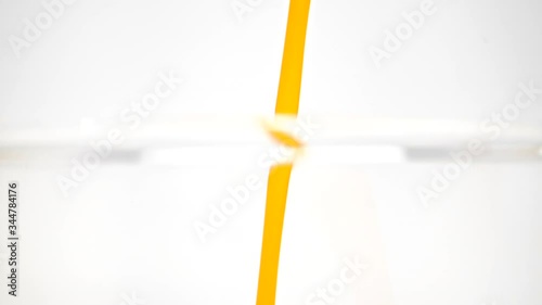 orange juice drop in glass slow motion
