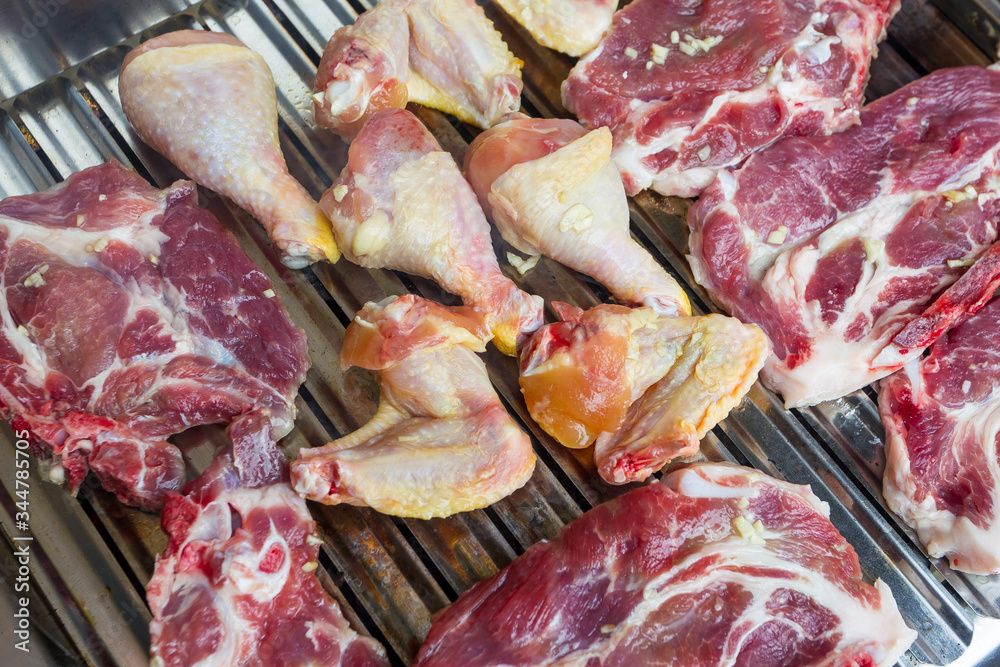 Chicken and pork meat on the barbecue
