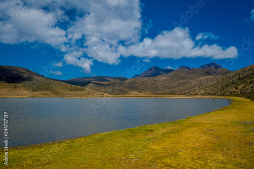 Shore of the lake Limpiopungo located in Cotopaxi national park  Ecuador in a sunny and windy day