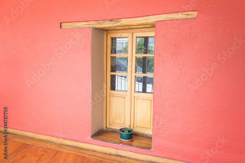 Close up of a pink wall with a wooden door in Quito Ecuador South America