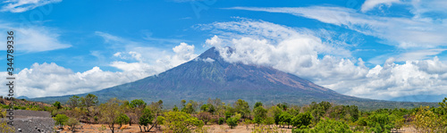Mt. Agung covered with clouds in front of the blue sky in Bali