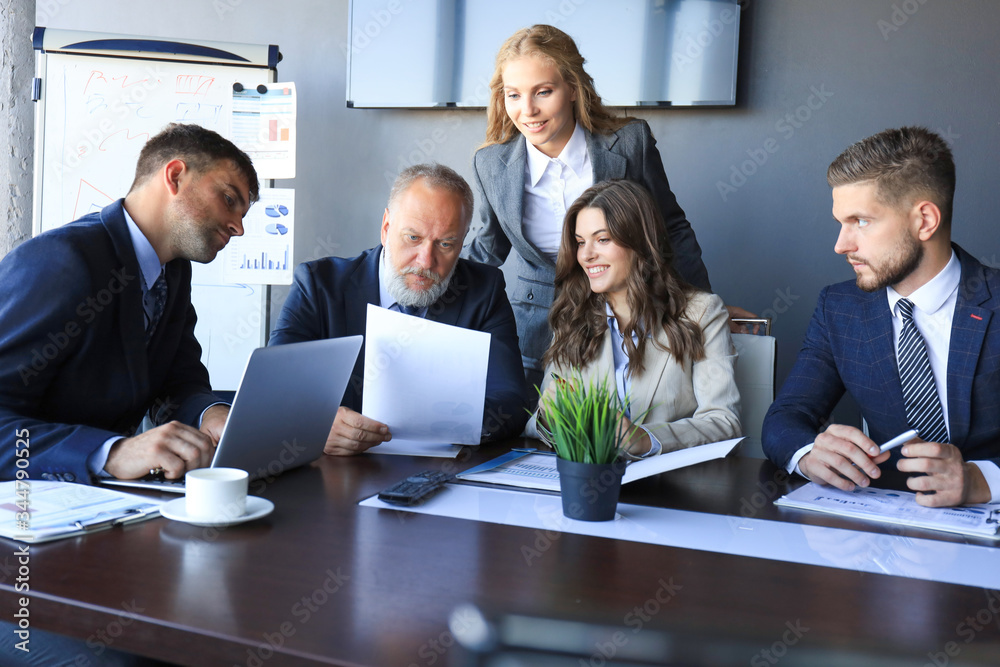 Group of business partners discussing ideas and planning work in office. Group of business partners discussing ideas and planning work in office.