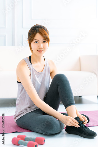 Young woman practicing yoga at home in the living room