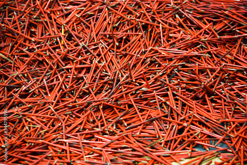 A lot of red pencils chaotic arranged
