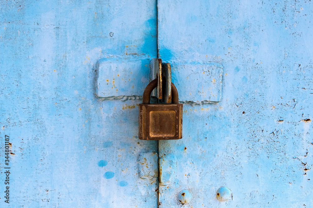 Padlock on an old rusty metal gate Padlock on an old rusty metal gate