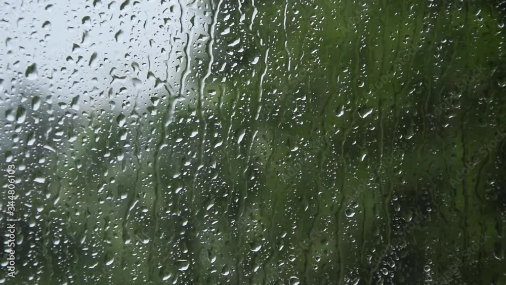 Falling rain into the window, weather concept
Falling rain into the window, weather concept