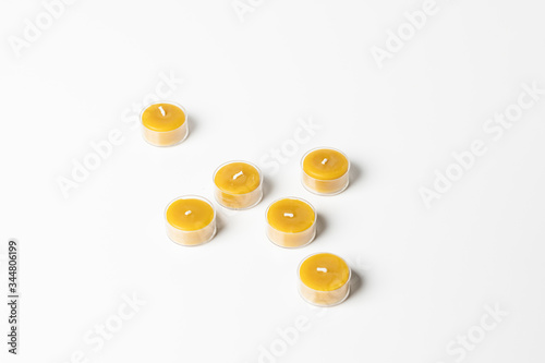 Small honey candles isolated on white background.