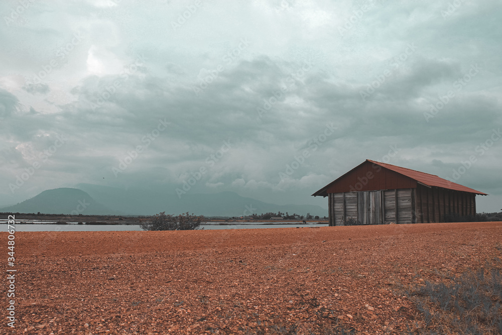 Cinematic photo of an abandoned salt storage house in the famous salt fields of Kampot, shows the effect of covid-19 lock downs on the local industry, economy and livelihood of the Cambodian people Cinematic photo of an abandoned salt storage house in the famous salt fields of Kampot, shows the effect of covid-19 lock downs on the local industry, economy and livelihood of the Cambodian people