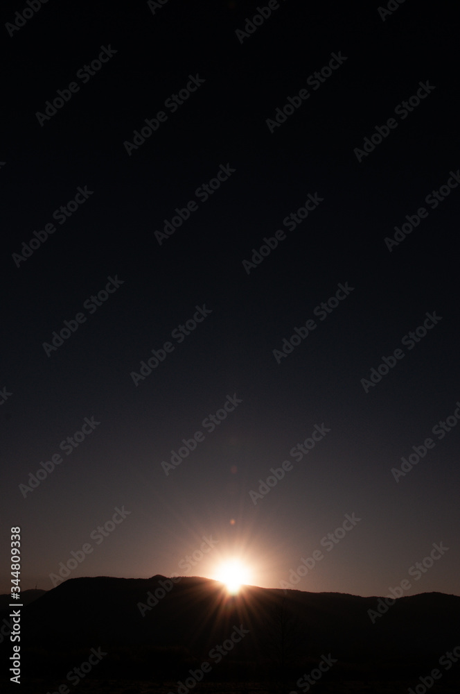 Sunrise behind a mountain top Sunrise behind a mountain top