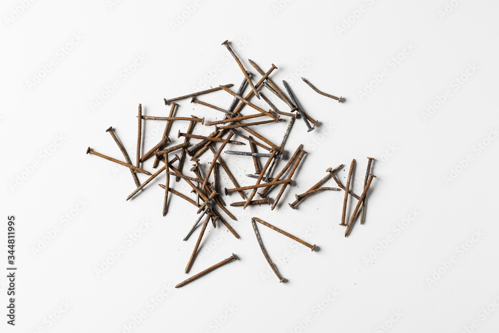 Rusty nails piling isolated on white background.