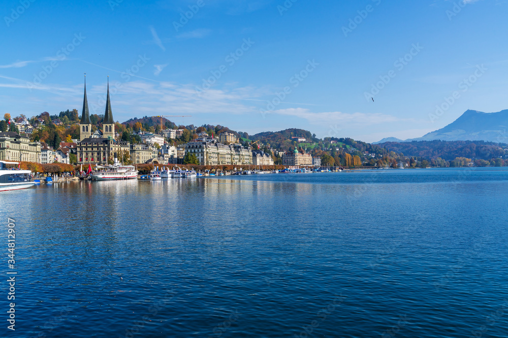 Embankment of the Reuss with pleasure tour boats and cathedral of St. Leodegar, Lucerne, Switzerland