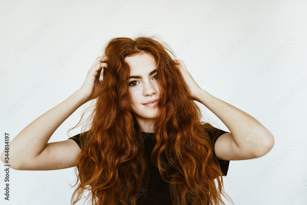 the thick curly long luxurious hair of a young virgin is perfectly shaded by a black T-shirt the thick curly long luxurious hair of a young virgin is perfectly shaded by a black T-shirt