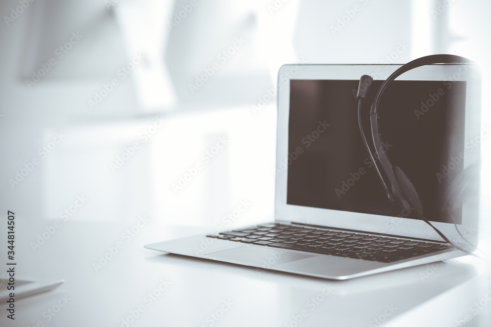 Fototapeta premium Call center and communication support, customer service help desk. VOIP headset on laptop computer