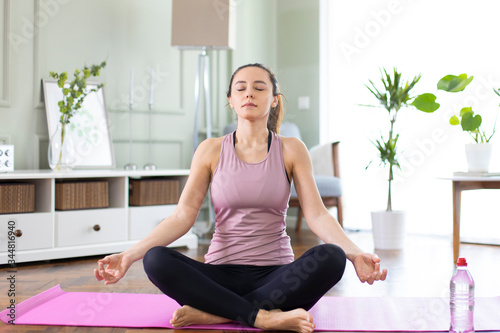 Young sporty woman practicing yoga photo
